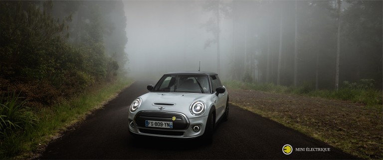 MINI Electric parked on foggy road. 